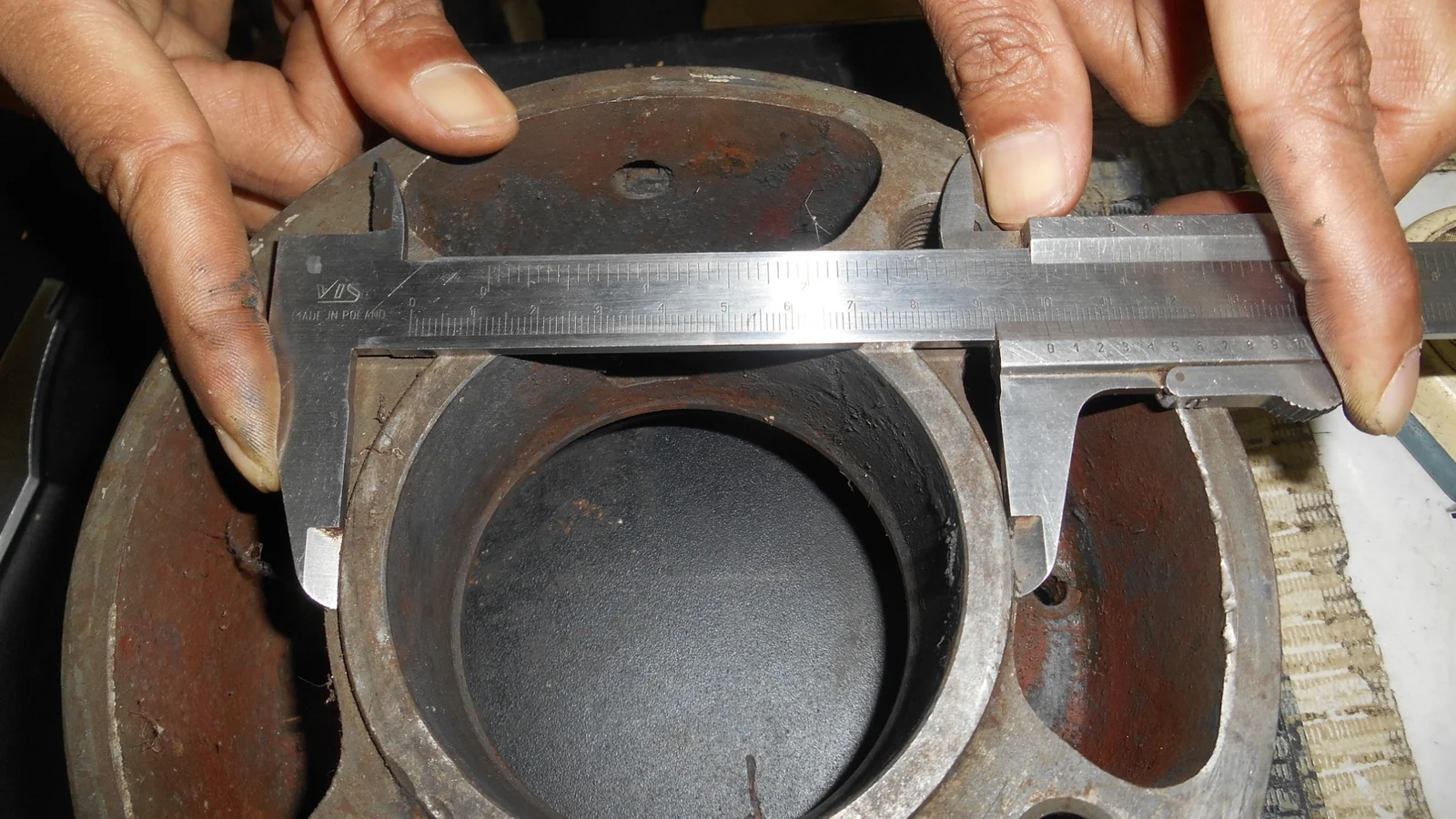 Bush measurement using vernier caliper showing 23.95 mm